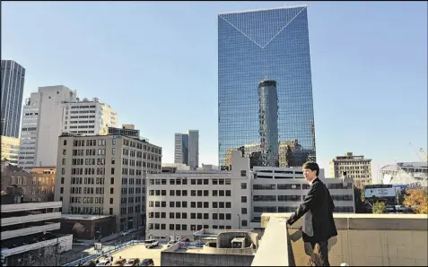  ?? HYOSUB SHIN PHOTOS / HSHIN@AJC.COM ?? Daniel Lentz looks at the city from the rooftop deck of his downtown loft. The 28-year-old, like others in his generation, was drawn in part to Donald Trump’s candidacy because of his economic message.