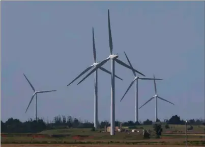  ?? PHOTO/ ?? Wind turbines are pictured near El Reno, Okla., on June 12. Oklahoma rolled out the red carpet to the growing wind industry two decades ago with the promise of generous state tax incentives and a steady stream of wind sweeping down the Central Plains. AP FILE SUE OGROCKI