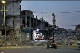  ?? AP PHOTO — SAMYA KULLAB ?? Mounds of rubble, remnants of the battle to retake the city three years ago from the Islamic State group, remain in the Old City of Mosul, Iraq, on Nov. 29.