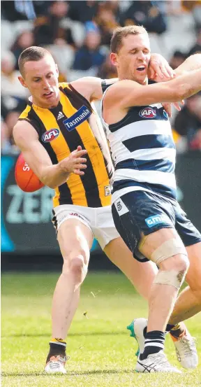  ?? Picture: HAMISH BLAIR ?? HEADLINE ACT: Geelong captain Joel Selwood gets taken high by Hawthorn’s Tom Scully in Sunday’s match at the MCG.