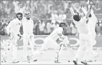  ?? (Reuters photo) ?? The Indian players celebrate after last Ravichandr­an Ashwin. man Neil Wagner is dismissed by