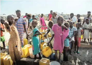  ?? | MSF/Igor Barbero ?? WOMEN and children queue at a water point in the Malakal Protection of Civilians site, in north-east South Sudan, where more than 29 000 internally displaced people continue to live today.