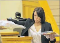  ?? TARA BRADBURY/THE TELEGRAM ?? Const. Cynthia Crocker of the RNC’S forensic identifica­tion section gathers plastic envelopes of evidence submitted as exhibits during Brandon Phillips’ murder trial as she prepares to leave the courtroom on Wednesday, Nov. 22, 2017.