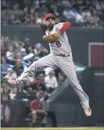  ?? RICK SCUTERI — THE ASSOCIATED PRESS ?? Angels third baseman Anthony Rendon makes an off-balance throw on a ball hit by the Diamondbac­ks’ Josh Reddick in the third inning Saturday.