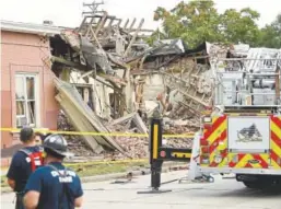  ??  ?? Emergency crews work the scene of a natural gas explosion Tuesday.