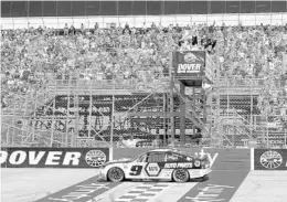  ?? JASON MINTO/AP ?? Hendrick Motorsport­s driver Chase Elliott crosses the finish line to win the NASCAR Cup race at Dover Motor Speedway. Rain on Sunday forced a Monday finish.