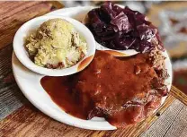  ??  ?? German sides — in this case, German potato salad and red cabbage — complement the homey meatloaf at Schilo's.