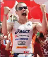  ?? Penticton Herald file photo ?? Jeff Symonds celebrates at the finish line after winning last year’s Challenge Penticton triathlon. The local favourite will return Sunday to defend his title.