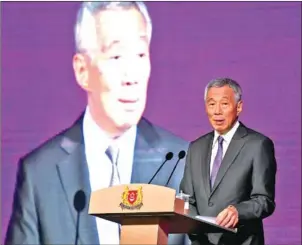  ?? ROSLAN RAHMAN/AFP ?? Singapore’s Prime Minister Lee Hsien Loong speaks at a business forum on the sidelines of the 33rd Asean summit in Singapore on Monday.