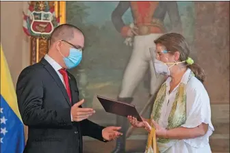  ?? YURI CORTEZ / AFP ?? Isabel Brilhante Pedrosa (right), the European Union’s ambassador, on Wednesday receives a letter from Jorge Arreaza, Venezuela’s foreign minister, stating that she is persona non grata.