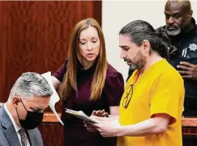  ?? Brett Coomer/Staff photograph­er ?? Robert Solis, on trial for murder, goes over some papers with his lawyer, Mandy Miller, as he considers whether to represent himself or get new counsel.