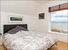  ??  ?? The bedroom boasts stunning coastal views.