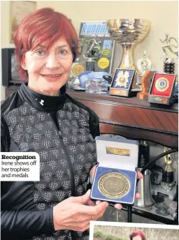  ??  ?? Recognitio­n Irene shows off her trophies and medals