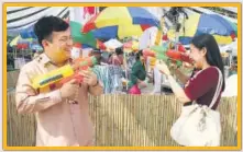  ?? ?? Cambodian ambassador Kuong Koy engaged in a fun watergun fight with his wife Seng Phalla