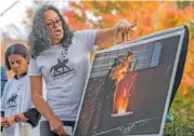  ?? CAL CARY/THE DAILY PROGRESS VIA AP ?? Jalane Schmidt, director of the Memory Project at the University of Virginia Karsh Institute of Democracy, points at the photos of the statue of Robert E. Lee being melted during a news conference Thursday in Charlottes­ville, Va.