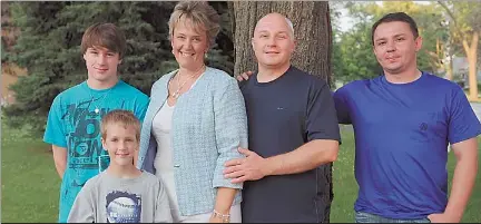 ?? RICHARD A. CHAPMAN~SUN-TIMES ?? Walter Polovchak (second from right) and his wife, Margaret, pose with their sons, Alec, 16, and Kyler, 8, and Walter’s brother Michael.