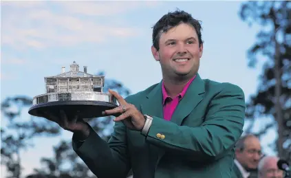  ?? PHOTO: REUTERS ?? Master of his trade . . . Texan Patrick Reed holds the winner’s trophy and wears his green jacket after winning the 2018 Masters tournament at the Augusta National Golf Club yesterday.