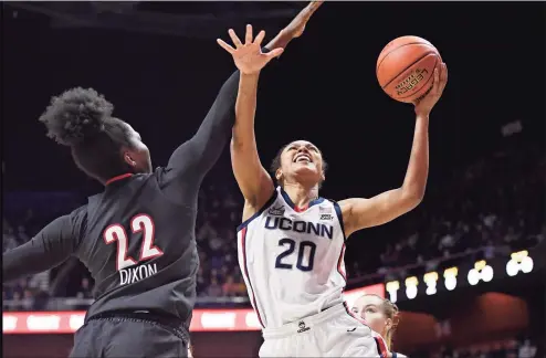  ?? Jessica Hill / Associated Press ?? UConn’s Olivia Nelson-Ododa (20) is fouled by Louisville’s Liz Dixon (22) in the first half on Sunday in Uncasville.