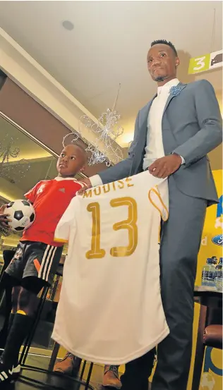  ?? Picture: GALLO IMAGES ?? TURNING A NEW CHAPTER: Teko Modise and young fan Teko during the launch of the book, ‘The Curse of Teko Modise’ at Exclusive Books Mall of Rosebank in Johannesbu­rg yesterday
