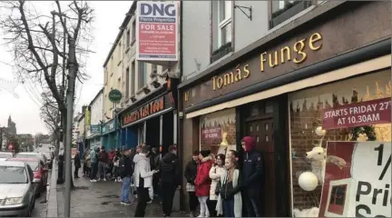  ??  ?? Long queue forms before the start of a half price sale at Funge’s Gorey.