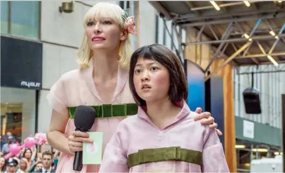 ?? NETFLIX ?? Tilda Swinton stars as Lucy Mirando, left, and Seo-Hyun Ahn is Mija in a scene from Okja. The film sparked controvers­y at Cannes when it was nominated for the top prize, because as a Netflix creation, it hadn’t had a theatrical release. The festival...