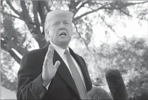  ?? Associated Press ?? ■ President Donald Trump stops to talk to members of the media Monday before walking across the South Lawn of the White House in Washington to board Marine One helicopter for a short trip to Andrews Air Force Base, Md., en route to Houston.