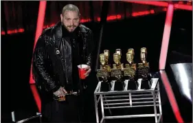  ?? (AP/Chris Pizzello) ?? Post Malone appears on stage Wednesday with his nine awards, including top male artist and top artist, at the Billboard Music Awards at Los Angeles’ Dolby Theatre.