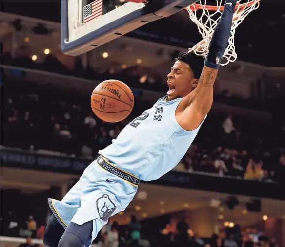  ?? APPEAL MAX GERSH / THE COMMERCIAL ?? Grizzlies' Ja Morant (12) dunks the ball Saturday, Feb. 29, 2020, during a game against the Lakers at Fedexforum in downtown Memphis.