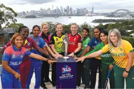  ?? AFP ?? Captains of the competing teams at the Twenty20 Women’s World Cup in Australia (from left) Thailand’s Sornnarin Tippoch, Stafanie Taylor of West Indies, India’s Harmanpree­t Kaur, New Zealand’s Sophie Devine, Australia’s Meg Lanning, England’s Heather Knight, Salma Khatun of Bangladesh, Sri Lanka’s Chamari Atapattu, Pakistan’s Bismah Maroof and South Africa’s Dane van Niekerk pose with the World Cup trophy at Taronga Zoo in Sydney on Monday, ahead of the competitio­n that begins on Friday. —