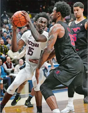  ?? JESSICA HILL/AP PHOTO ?? UConn’s Sidney Wilson, left, is guarded by SMU’s Isiaha Mike, front right, during the second half of Thursday’s game at Gampel Pavilion in Storrs. UConn won 76-64.