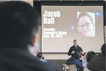  ?? Photos by Paul Kuroda / Special to The Chronicle ?? Jeffrey Solomon shows a slide about a South Carolina school shooting as he trains Oakland Unified School District employees.