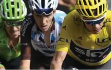  ?? LIONEL BONAVENTUR­E/AFP/GETTY IMAGES ?? Christophe­r Froome, wearing the overall leader’s yellow jersey, Romain Bardet, centre, and Rigoberto Uran climb the Col d’Izoard on Thursday.