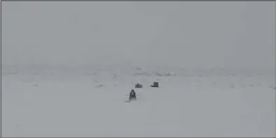  ?? Photo by Diana Haecker ?? ICE MINING— Miners reestablis­hed their mining camps on the sea ice in front of Nome in between storms on Friday, Jan. 24.