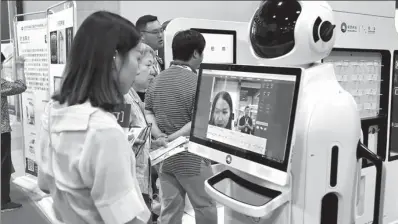  ?? LIU XIANGUO / FOR CHINA DAILY ?? A visitor tries out a machine for fitting glasses at the 2017 China Internatio­nal Internet of Things Technology Expo in Beijing.