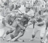  ?? AP FILES ?? Syracuse’s Floyd Little tries to run through defenders during a loss to Baylor in 1966.