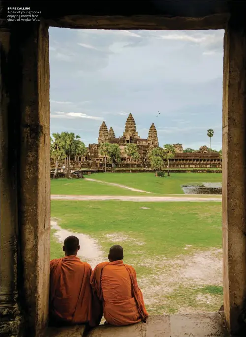  ??  ?? SPIRE CALLING
A pair of young monks enjoying crowd-free views of Angkor Wat.