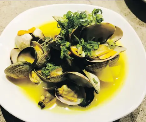  ?? POSTMEDIA NEWS/FILES ?? Clams in turmeric broth at the Ugly Dumpling, which aims to be more than a dumpling house, says chef Darren Gee.