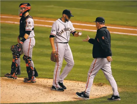  ?? Doug Pensinger / Getty Images 2015 ?? Giants manager Bruce Bochy, shown removing reliever Jeremy Affeldt from a 2015 game at Colorado, made ample use of his bullpen during San Francisco’s stretch of three World Series titles in five seasons (2010, 2012 and 2014).