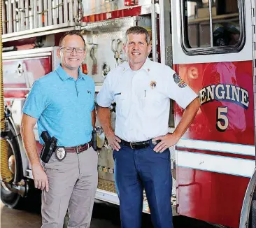  ?? [PHOTO PROVIDED BY MELINDA INFANTE] ?? Edmond Police Chief J.D. Younger, left, and Edmond Fire Chief Chris Goodwin are settling down in their new posts and using each other as a mini-support system.