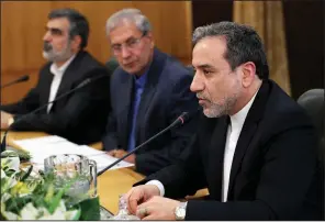  ?? AP/EBRAHIM NOROOZI ?? Abbas Araghchi (right), Iran’s deputy foreign minister, said Sunday Iran is open to negotiatio­ns over its nuclear developmen­t program during a news conference in Tehran. He is joined by Iran’s atomic energy spokesman Behrouz Kamaluandi (left) and government spokesman Ali Rabier.