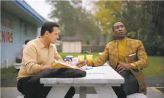  ?? Universal Pictures ?? Viggo Mortensen (left) and Mahershala Ali set out on a road trip, with Ali as the erudite pianist on tour and Mortensen as the crude club bouncer serving as his chauffeur, in “Green Book.”