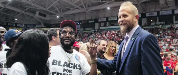  ?? SAUL LOEB/AFP/GETTY IMAGES ?? Brad Parscale, right, reelection campaign manager for U.S. President Donald Trump, speaks with supporters at a campaign rally, in Estero, Florida, in October.