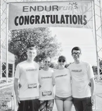  ?? [VERONICA REINER] ?? ENDURrun volunteers waited for racers next to the finish line at Saturday’s 10 km run in Conestogo. The time limit for this course was an hour and 15 minutes.