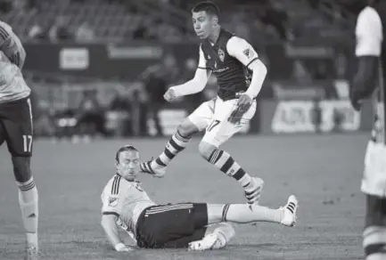  ??  ?? Dillon Serna of the Rapids watches his game-winning goal over the fallen Nuno Coelho of Sporting Kansas City in a game last season. But later that season, Serna suffered a serious right knee injury that sidelined him. AAron Ontiveroz, Denver Post file