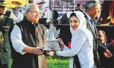  ?? PTI ?? Satya Pal Malik presents an award to a winner of Urdu Calligraph­y during ‘Chinar Youth Festival-2018’, in Srinagar.