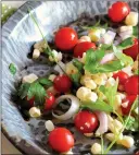  ?? COURTESY OF LYNDA BALSLEV ?? Lime juice and olive oil bind the flavors of tomatoes, corn, chiles, onion and parsley in this no-fuss salad.