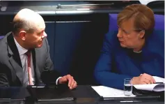  ??  ?? German Chancellor Angela Merkel and Finance Minister Olaf Scholz attend a session of the lower house of parliament Bundestag in Berlin, Germany. Scholz says he launched an initiative designed to help states react to so-called fiscal dumping in support of embryonic OECD plans designed to fight tax transparen­cy and cross-border tax evasion. — Reuters photo