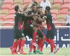  ?? — AFP ?? UAE Al Ahli’s players celebrate after scoring during the AFC Champions League match at the King Abdullah Stadium in Jeddah.