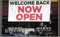  ?? JEFF CHIU / AP FILE ?? In this March 4 file photo, a sign reading “Welcome Back Now Open” is posted on the window of a Morton’s Steakhouse restaurant in San Francisco.