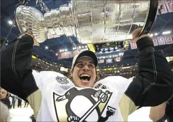  ?? Peter Diana/Post-Gazette ?? Sidney Crosby lifts the Stanley Cup at Detroit’s Joe Louis Arena, June 12, 2009.
